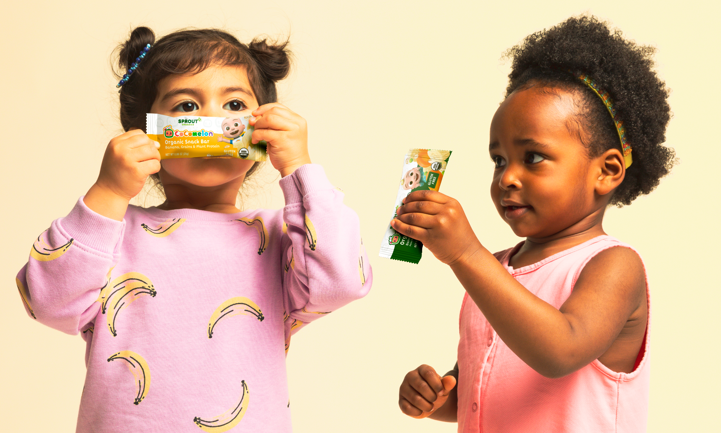 two children holding cocomelon snack bars